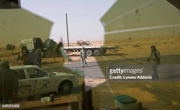 Opposition troops man a checkpoint on the edge of Ras Lanuf after taking the city back from troops loyal to Muammar al-Gaddafi, in Ras Lanuf, Libya,...