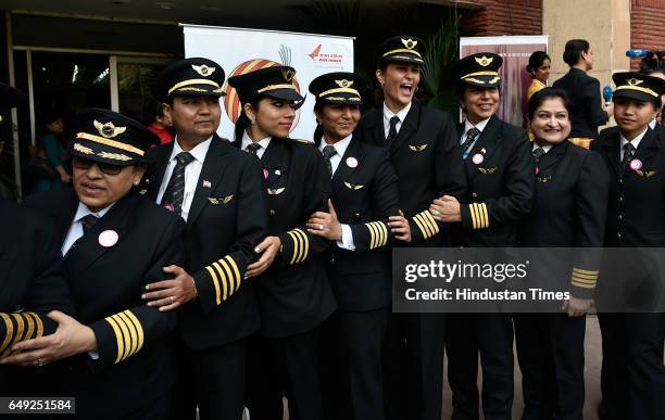 Indian female pilots of Air India, pose for a photograph after their ceremony on the eve of international women's day on March 7, 2017 in New Delhi,...