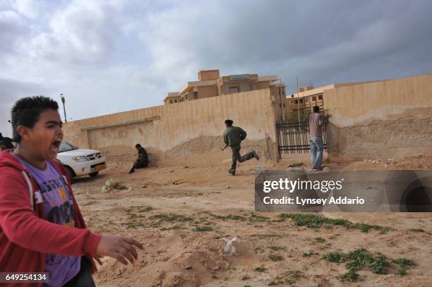 Libyans panic after hearing a plane overhead in anticipation of possible air strikes, in Ras Lanuf, Libya, Saturday, March 5, 2011. Dangerous...