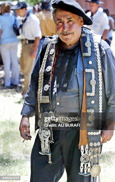 Gaucho displays his wide belts carrying them on his shoulders during the 'jineteadas' in Carmen de Areco City, in Buenos Aires province, Argentina,...