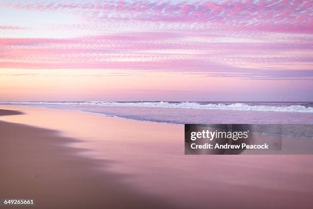 sunrise beach at sunset - sunset in the ocean stock-fotos und bilder