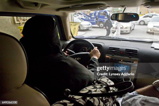 Saudi woman drives in Riyadh, Saudi Arabia, while accompanied by her husband during a call for women to come out and drive in a protest against the...