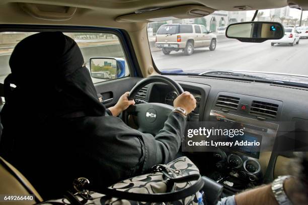 Saudi woman drives in Riyadh, Saudi Arabia, while accompanied by her husband during a call for women to come out and drive in a protest against the...