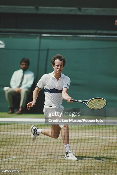 American tennis player John McEnroe pictured in action competing to reach the quarterfinals of the Men's Singles tournament at the Wimbledon Lawn...