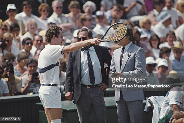 American tennis player John McEnroe pictured in discussion with match officials during competition to reach the quarterfinals of the Men's Singles...