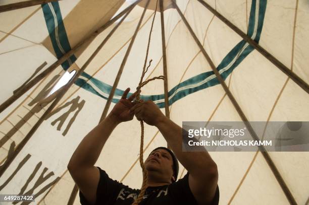 Aldo Seoane, a Yoeme Native American, sets up a teepee near the Washington Monument in Washington, DC, on March 7, 2017 at the start of a four-day...
