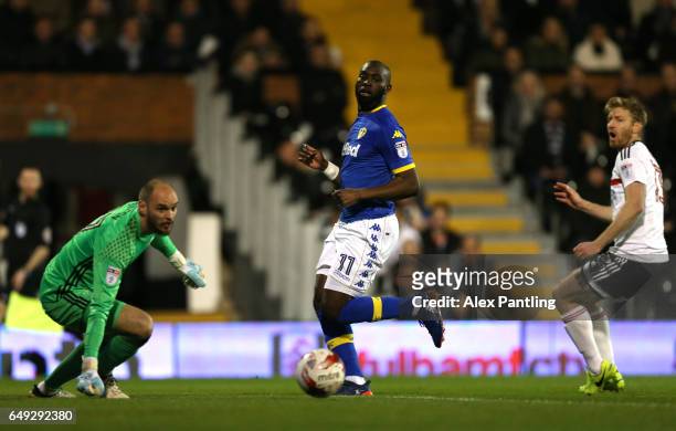 David Button of Fulham and Souleymane Doukara of Leeds United watch on as Tim Ream of Fulham scores an own goal during the Sky Bet Championship match...