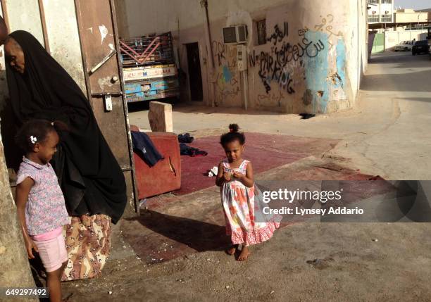 Saudi girl stands outside her home where she and her family live in squalor, in a neighborhood of south Riyadh, Saudi Arabia, March 1, 2013. Like...