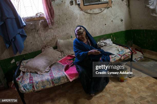 Selma Saleh, a poor Saudi woman, sits on her bed in a neighborhood in south Riyadh, Saudi Arabia, March 1, 2013. Like many families across Saudi...