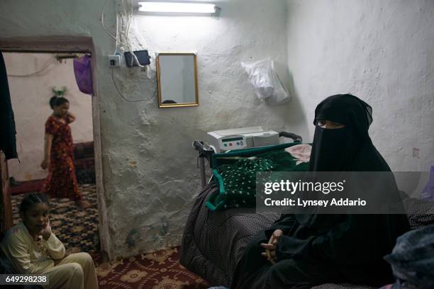 Fatima Hazazi sits in her home next to the dialysis machine she requires to treat her kidney problem, in Riyadh, Saudi Arabia, March 3, 2013. Like...