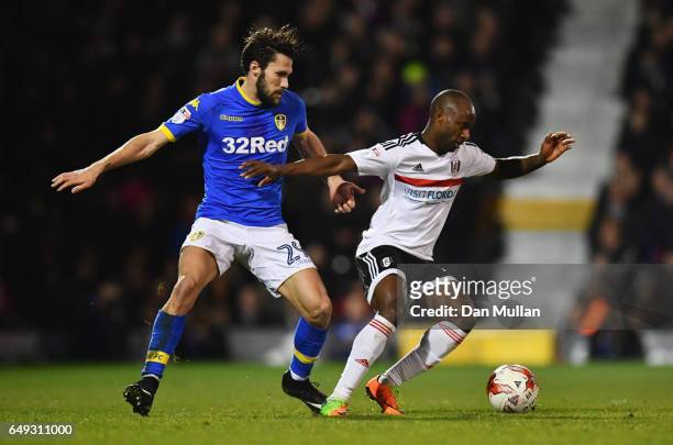 Sone Aluko of Fulham holds off Alfonso Pedraza of Leeds United during the Sky Bet Championship match between Fulham and Leeds United at Craven...