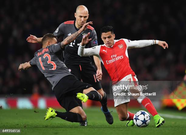 Alexis Sanchez of Arsenal battles with Rafinha and Arjen Robben of Bayern Muenchen during the UEFA Champions League Round of 16 second leg match...