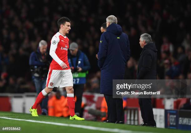 Laurent Koscielny of Arsenal walks past Arsene Wenger, Manager of Arsenal as he is sent off during the UEFA Champions League Round of 16 second leg...