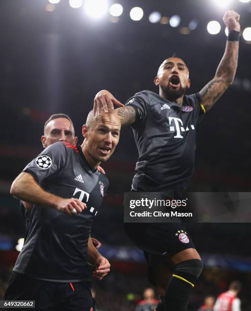 Arjen Robben of Bayern Muenchen celebrates as he scores their second goal with team mates Arturo Vidal and Franck Ribery during the UEFA Champions...