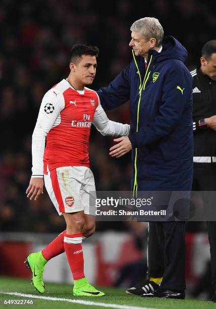 Alexis Sanchez of Arsenal is consoled by Arsene Wenger, Manager of Arsenal as he is substituted during the UEFA Champions League Round of 16 second...