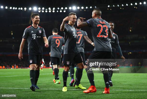 Arturo Vidal of Bayern Muenchen celebrates with Rafinha and team mates as he scores their fourth goal during the UEFA Champions League Round of 16...