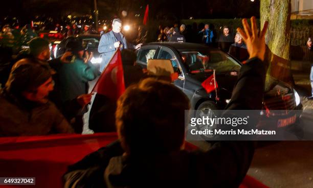 Turkish Foreign Minister Mevlut Cavusoglu emerges from the Turkish consulate after speaking to supporters of the upcoming referendum in Turkey on...