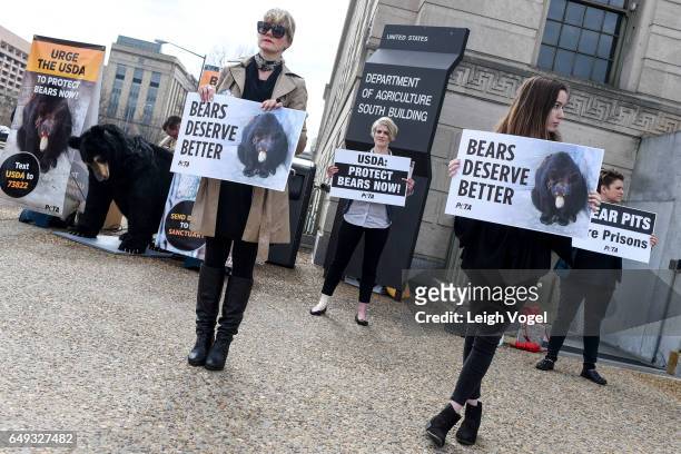 Animal rights supporters, alongside "Bernard", PETA's seven-foot-tall robotic bear voiced by Oscar-winning actor Casey Affleck, call on the USDA to...