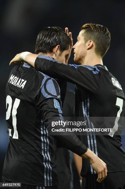 Real Madrid's forward Alvaro Morata celebrates with Real Madrid's Portuguese forward Cristiano Ronaldo after scoring at the end of the UEFA Champions...