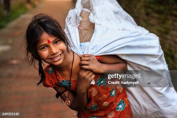 poor indian girl collecting plastic bottles for recycling - trabalho infantil imagens e fotografias de stock