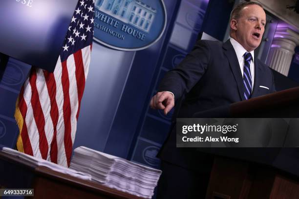 White House Press Secretary Sean Spicer compares as he points to a copy of the Obamacare Bill and a copy of the new House Republican Healthcare Bill...