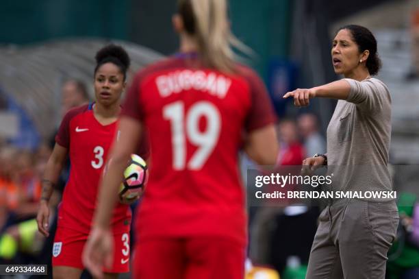 Germany's coach Steffi Jones yells while England's defender Demi Stokes waits to throw the ball in during the She Believes Cup at RFK Stadium March...