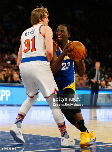 Draymond Green of the Golden State Warriors in action against Ron Baker of the New York Knicks at Madison Square Garden on March 5, 2017 in New York...