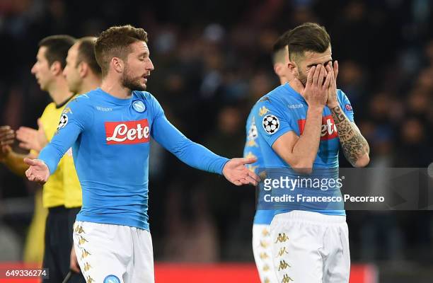 Napolis player Elseid Hysaj and Dries Mertens stand disappointed during the UEFA Champions League Round of 16 second leg match between SSC Napoli and...