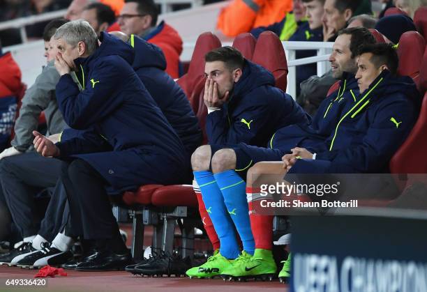 Arsene Wenger, Manager of Arsenal, Aaron Ramsey, Petr Cech and Alexis Sanchez of Arsenal look dejected on the bench during the UEFA Champions League...