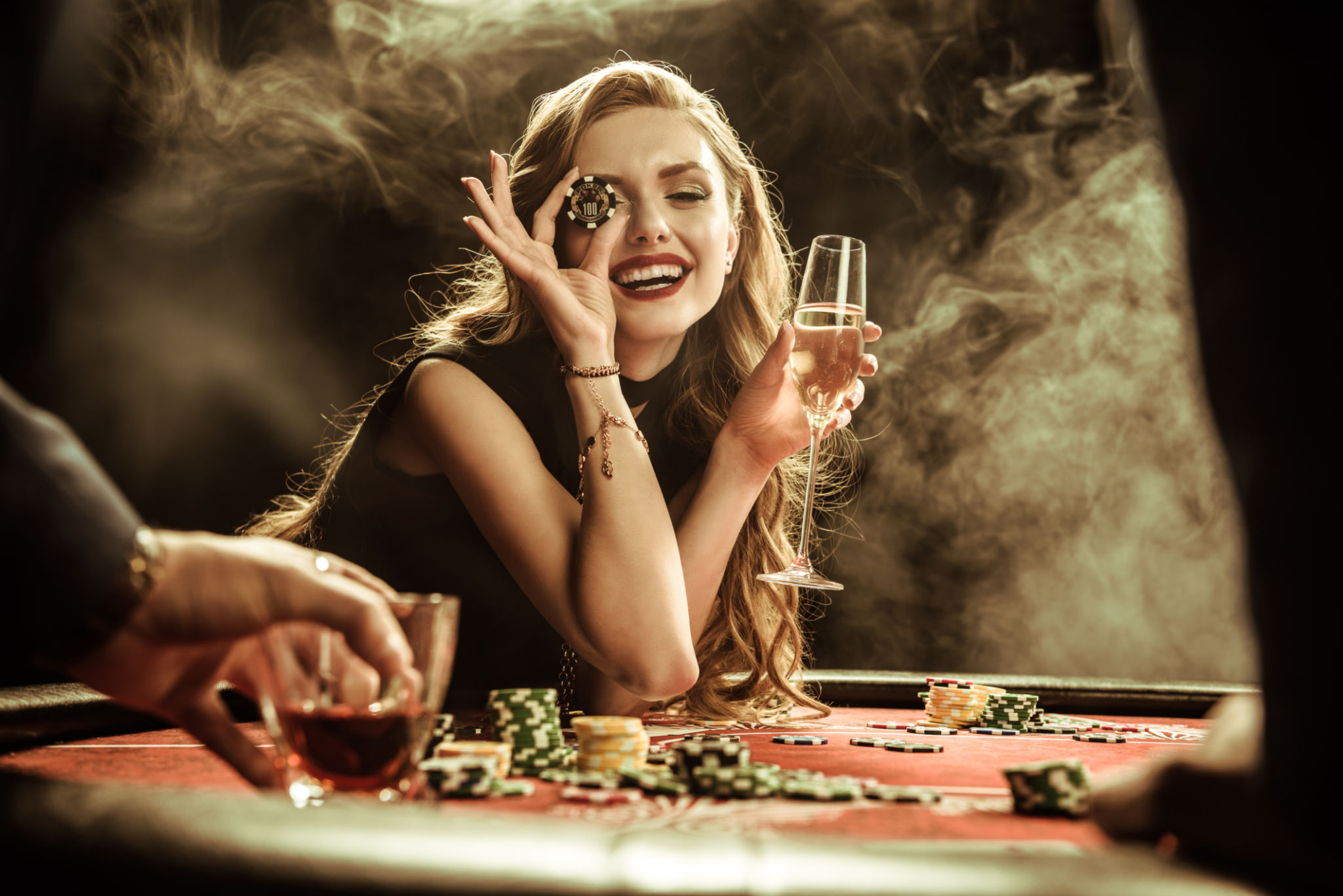 portrait of smiling woman with drink and poker chip portrait of smiling woman with drink and poker chip