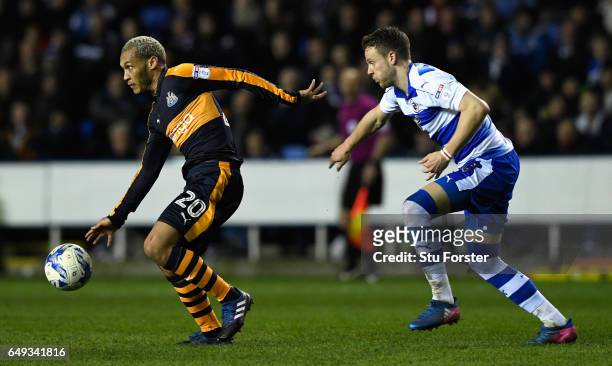Yoan Gouffran holds off the challenge of Chris Gunter of Reading during the Sky Bet Championship match between Reading and Newcastle United at...