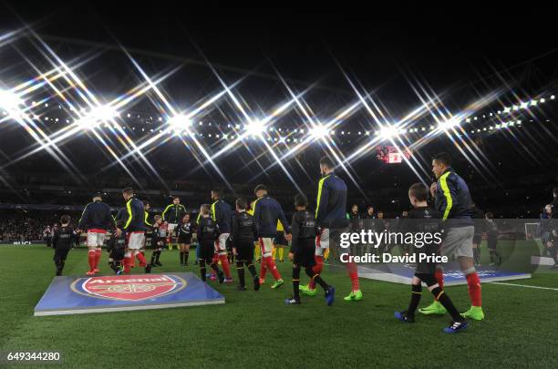 The Arsenal players walk out before the UEFA Champions League Round of 16 second leg match between Arsenal FC and FC Bayern Muenchen at Emirates...