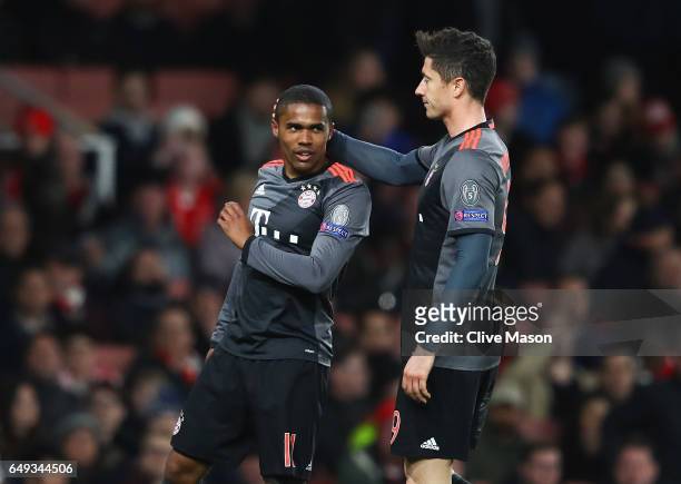 Douglas Costa of Bayern Muenchen celebrates as he scores their third goal with Robert Lewandowski during the UEFA Champions League Round of 16 second...