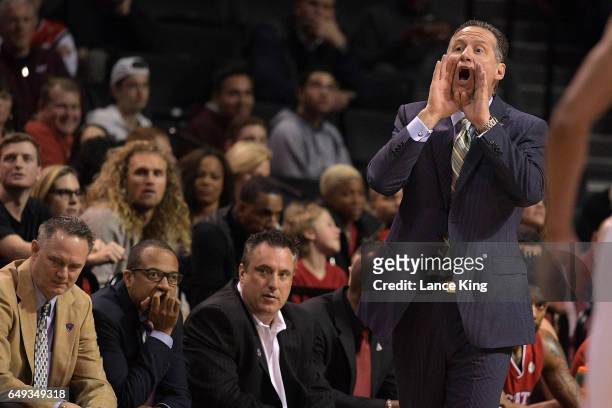 Head coach Mark Gottfried of the North Carolina State Wolfpack directs his team against the Clemson Tigers during the first round of the ACC...