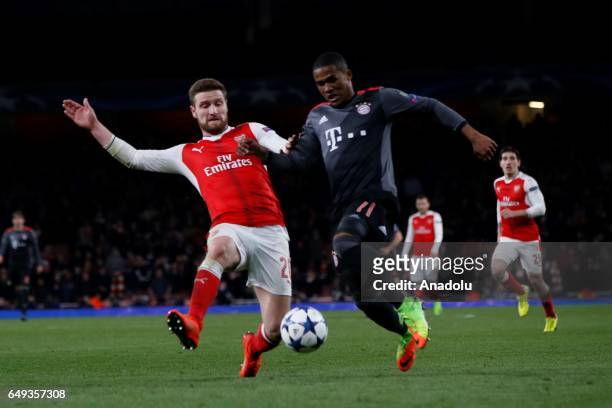 Arsenals Shkodran Mustafi vies with Bayern Munich's Douglas Costa during the UEFA Champions League match between Arsenal FC and Bayern Munich at...