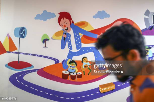 An employee walks past a decorated wall at the Flipkart Online Services Pvt. Headquarters in Bengaluru, India, on Friday, Feb. 3, 2017. Last summer,...