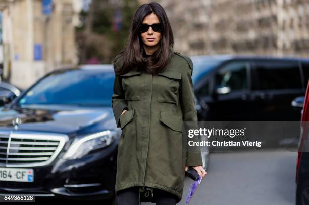 Barbara Martelo wearing an olive coat cropped denim jeans outside Miu Miu on March 7, 2017 in Paris, France.