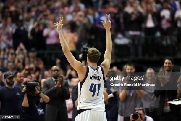 Dirk Nowitzki of the Dallas Mavericks celebrates after scoring his 30,000 career point in the second quarter against the Los Angeles Lakers at...