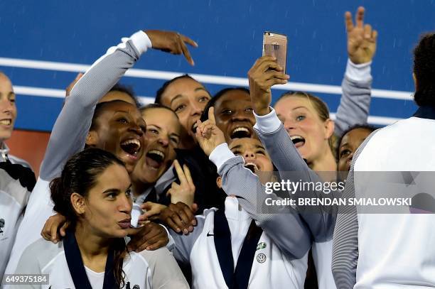 Members of France's team celebrate after defeating the United States to win the She Believes Cup at RFK Stadium March 7, 2017 in Washington, DC.