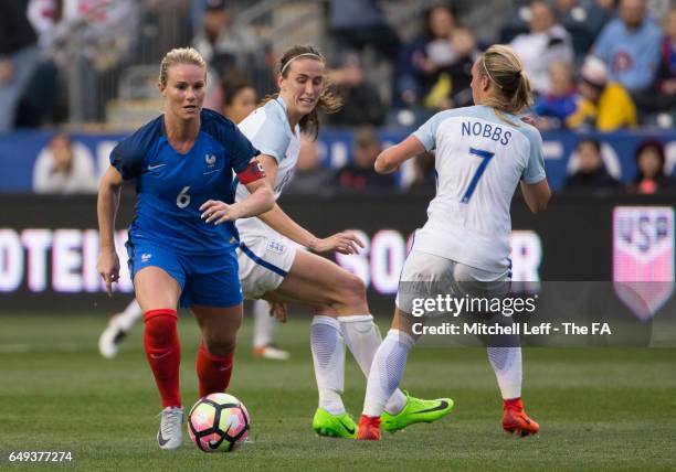 Amandine Henry of France controls the ball against Jill Scott and Jordan Nobbs of England during the SheBelieves Cup at Talen Energy Stadium on March...