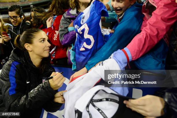 Alex Morgan of United States of America signs autographs for fans after France defeated the United States of America 3-0 during the 2017 SheBelieves...