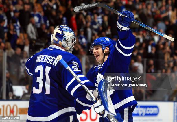 Frederik Andersen of the Toronto Maple Leafs is congratulated by Mitchell Marner following an NHL game against the Detroit Red Wings at Air Canada...