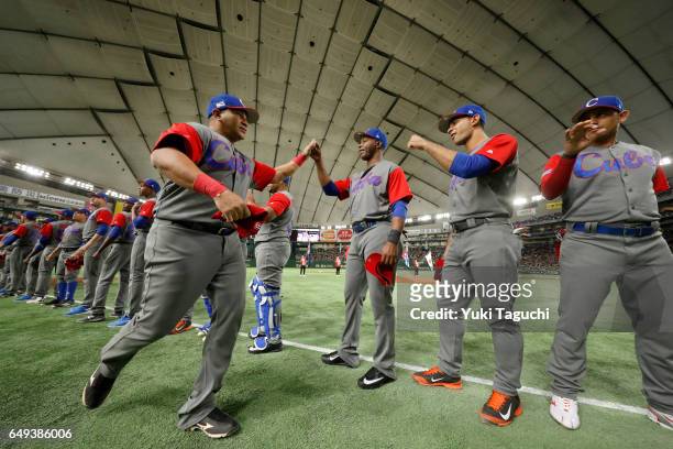 Frederich Cepeda of Team Cuba is greeted by teammates during player introductions prior to the Game 1 of Pool B against Team Japan at the Tokyo Dome...