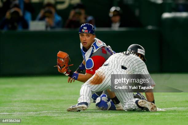 Frank Morejon of Team Cuba tags as Nobuhiro Matsuda of team Japan in second inning during the Game 1 of Pool B at the Tokyo Dome on Tuesday, March 7,...