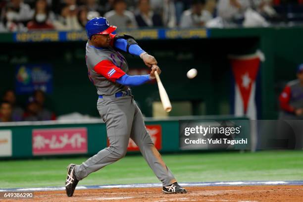 Alexander Ayala of Team Cuba hits sacrifice fly in third inning during the Game 1 of Pool B against Team Japan at the Tokyo Dome on Tuesday, March 7,...