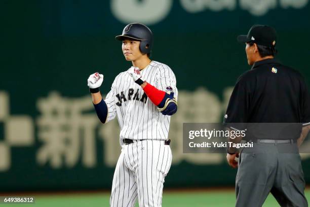 Hayato Sakamoto of Team Japan reacts to hitting an RBI double in fifth inning during the Game 1 of Pool B against Team Cuba at the Tokyo Dome on...