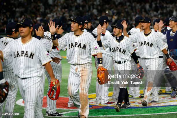 Nobuhiro Matsuda and Ryosuke Kikuchi of Team Japan celebrate with teammates after defeating Team Cuba in Game 1 of Pool B at the Tokyo Dome on...