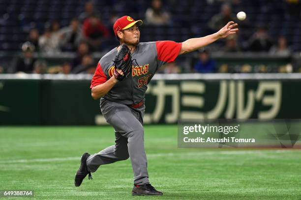 Pitcher Bruce Chen of China throws to the first base after fielding a grounder by Infielder Alexander Ayala of Cuba in the bottom of the third inning...