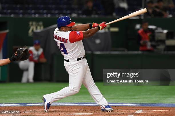 Outfielder Alfredo Despaigne of Cuba hits a single in the bottom of the third inning during the World Baseball Classic Pool B Game Two between China...