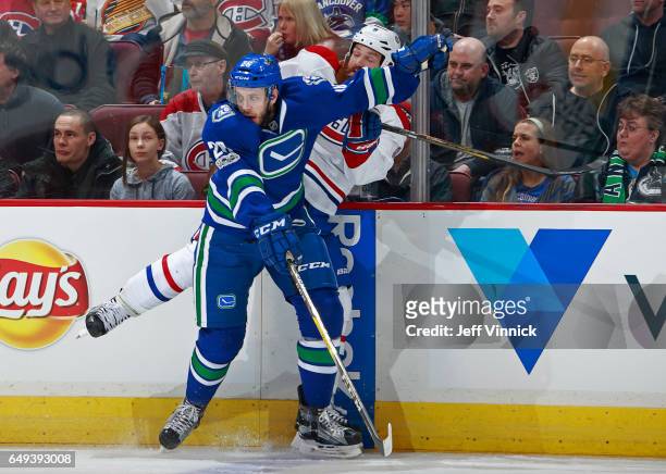 Joseph Cramarossa of the Vancouver Canucks checks Jordie Benn of the Montreal Canadiens during their NHL game at Rogers Arena March 7, 2017 in...
